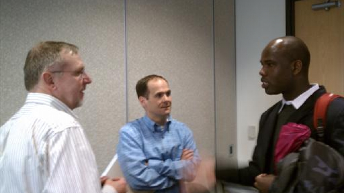 Peter Veit of WRI, Johnny Wilson of TNC and Emmanuel Sulle of University of Maryland talk after the meeting