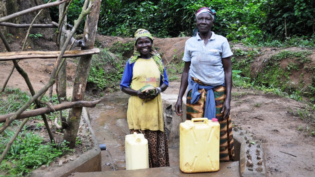 Women from Siiba Village, Masindi Distict, Uganda collecting water from Siiba spring which was rehabilitated through ABCG�s project